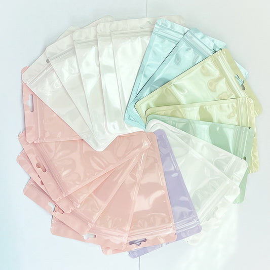 A Macaron color self-sealing bag, holographic bag, thickened transparent color bone bag, jewelry, sealed pocket, makeup brush, packaging bag.