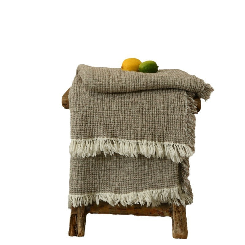 A woven cotton and linen fringed blanket