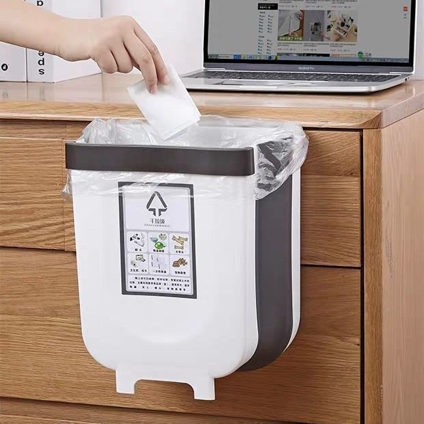 A kitchen trash can hanging type foldable