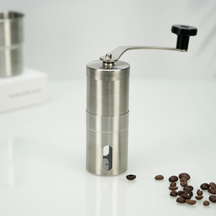 A stainless steel hand coffee grinder