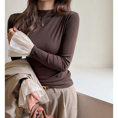 A top is worn inside the lace cuffs