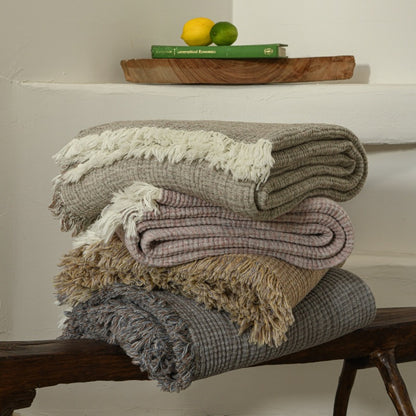 A woven cotton and linen fringed blanket