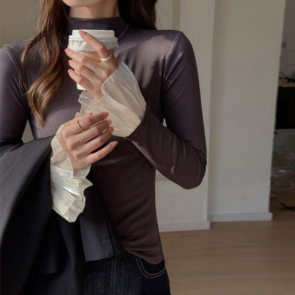 A top is worn inside the lace cuffs