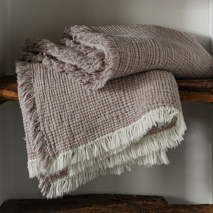 A woven cotton and linen fringed blanket