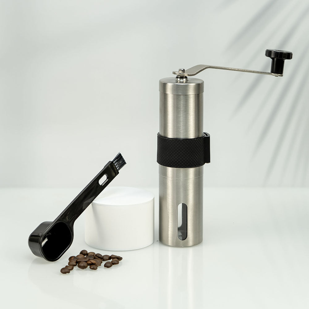 A stainless steel hand coffee grinder