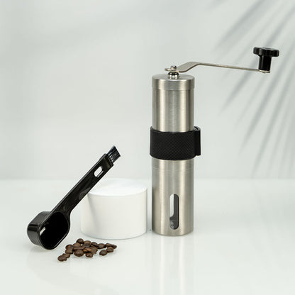 A stainless steel hand coffee grinder