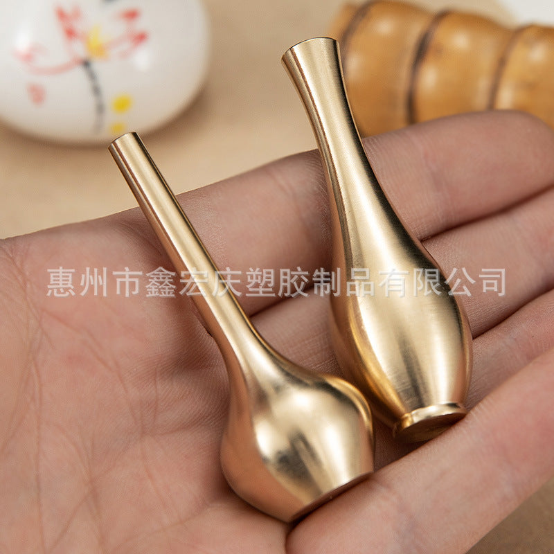 A brass mini vase ornament