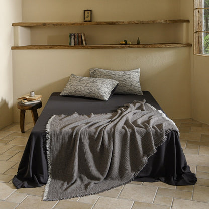 A woven cotton and linen fringed blanket
