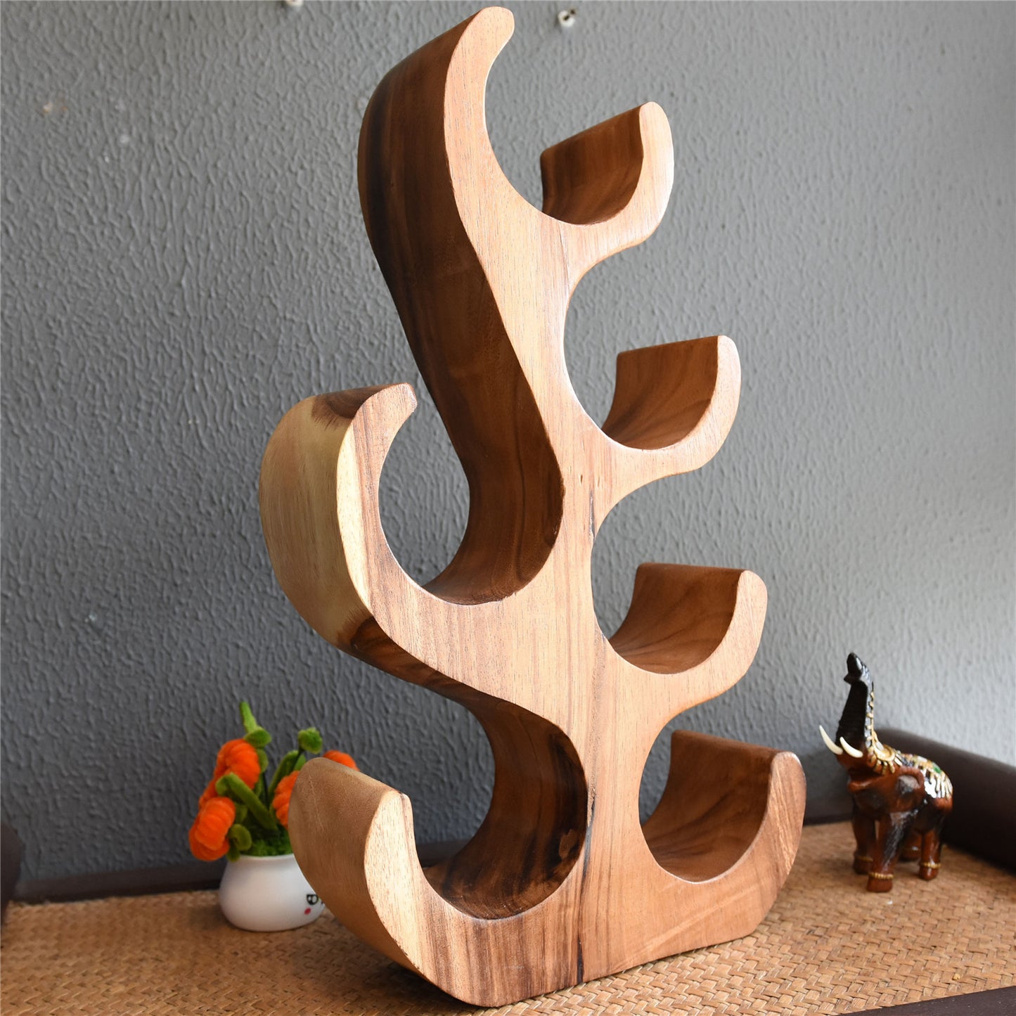 A teak wine rack ornament