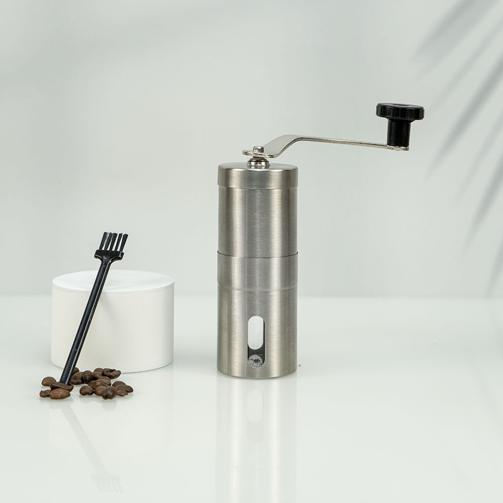 A stainless steel hand coffee grinder