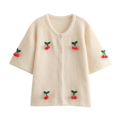 A cherry garnish sweater