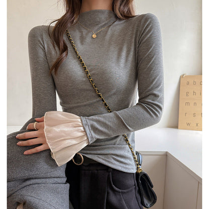 A top is worn inside the lace cuffs