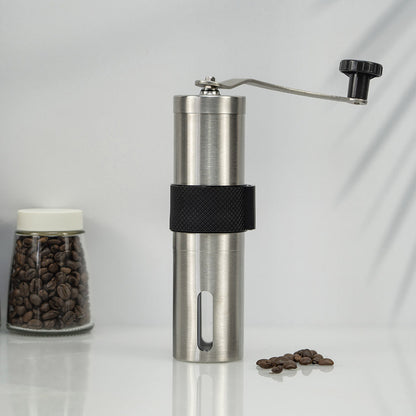 A stainless steel hand coffee grinder