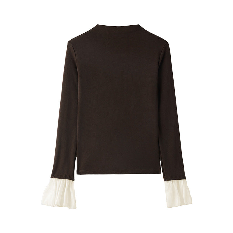 A top is worn inside the lace cuffs