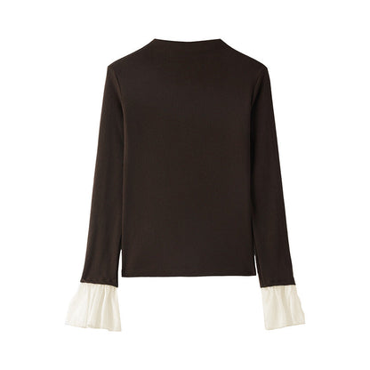 A top is worn inside the lace cuffs