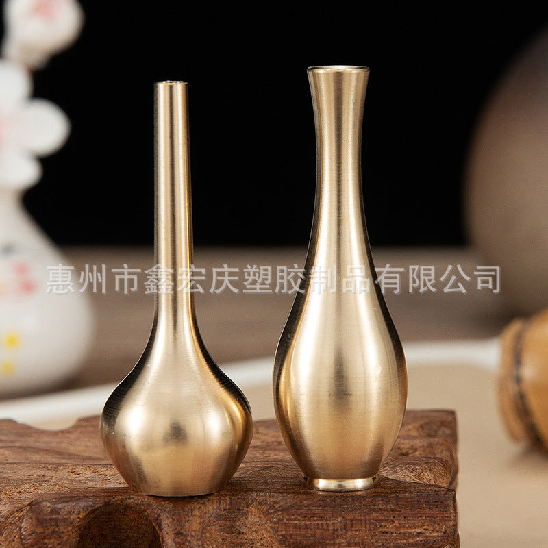 A brass mini vase ornament
