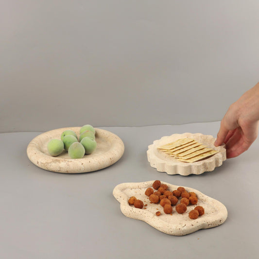 A geometric round travertine marble tray ornament